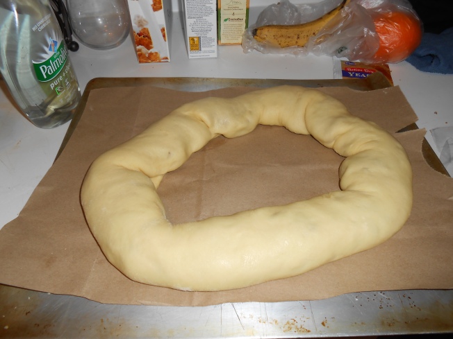 Starting from the outside, roll the dough over and over again, pushing the filling to stay in, until it forms a ring
